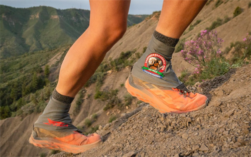 Low trail running gaiters protecting trail shoes from scree and debris on rocky hiking trails