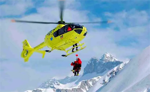 Mountain rescue helicopter performing an airlift, representing traditional SAR methods contrasted with new AI-powered drone technology