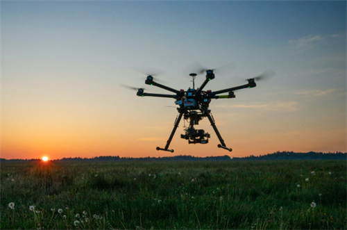 AI-powered search-and-rescue drone in flight at sunset, representing the technology used to locate missing hikers in wilderness areas