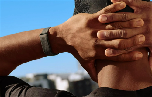 Fitness wristband worn during outdoor activity, showcasing a wearable device in a scenario where sweat-powered off-grid charging would be useful