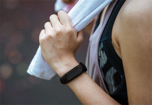Fitness tracker worn on a wrist during exercise, representing wearable devices that could use sweat for off-grid charging